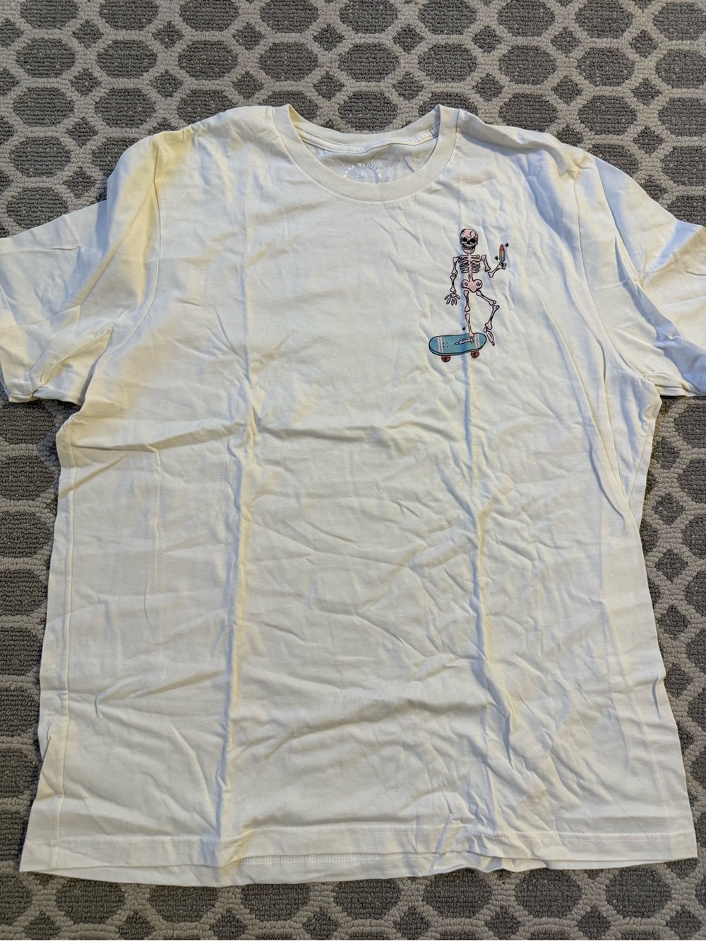 White Short-Sleeve Tee with Skateboarding Skeleton Graphic